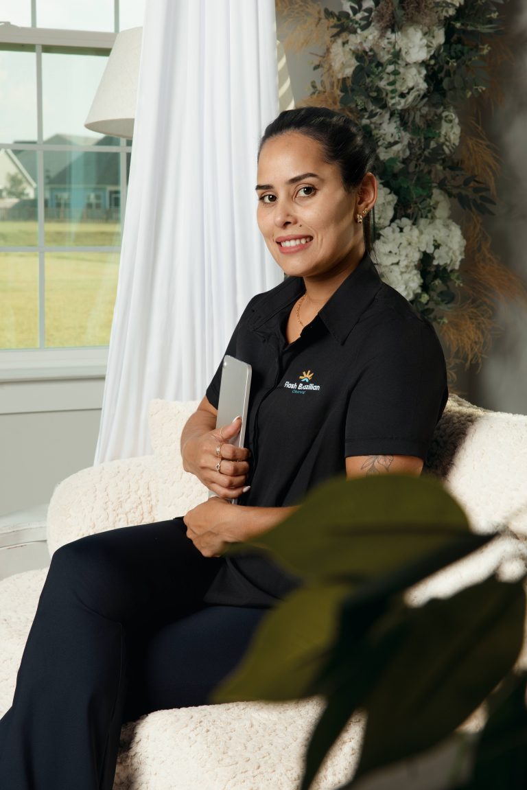 Gracielly, owner of Flash Brazilian Cleaning, sitting in a bright Charleston living room